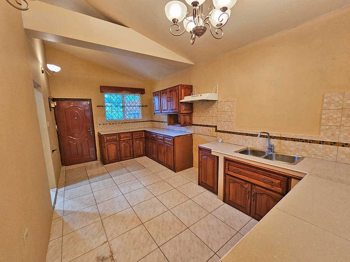 Spacious Kitchen in Calcutta Road Apt 1 Cornerstone- Bright kitchen with wooden cabinets and tiled flooring in Calcutta Road Apt 1.