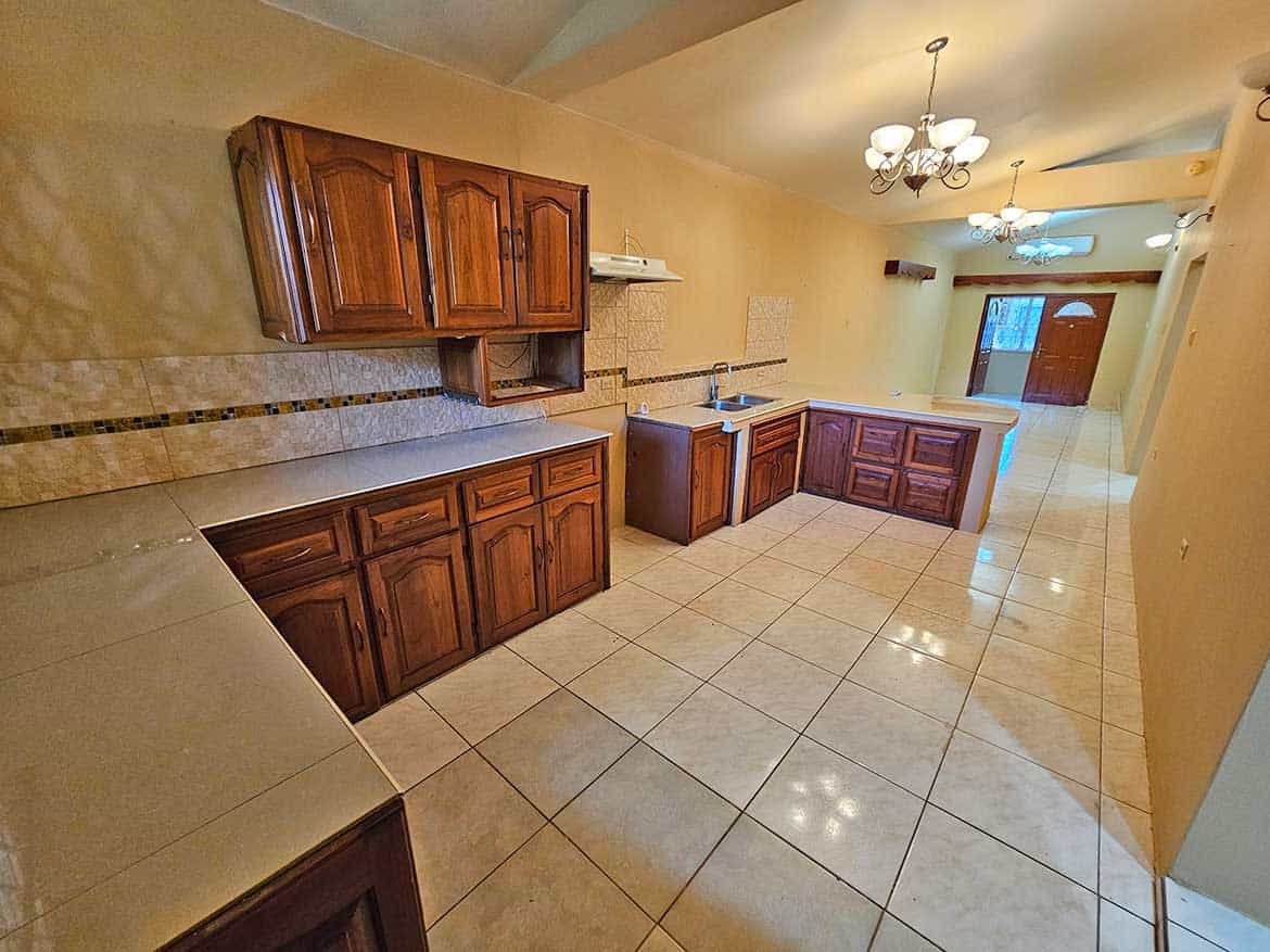 Spacious Kitchen in Calcutta Road Apt 1 Cornerstone- Bright, spacious kitchen with wooden cabinets and tiled flooring in Calcutta Road Apt 1.