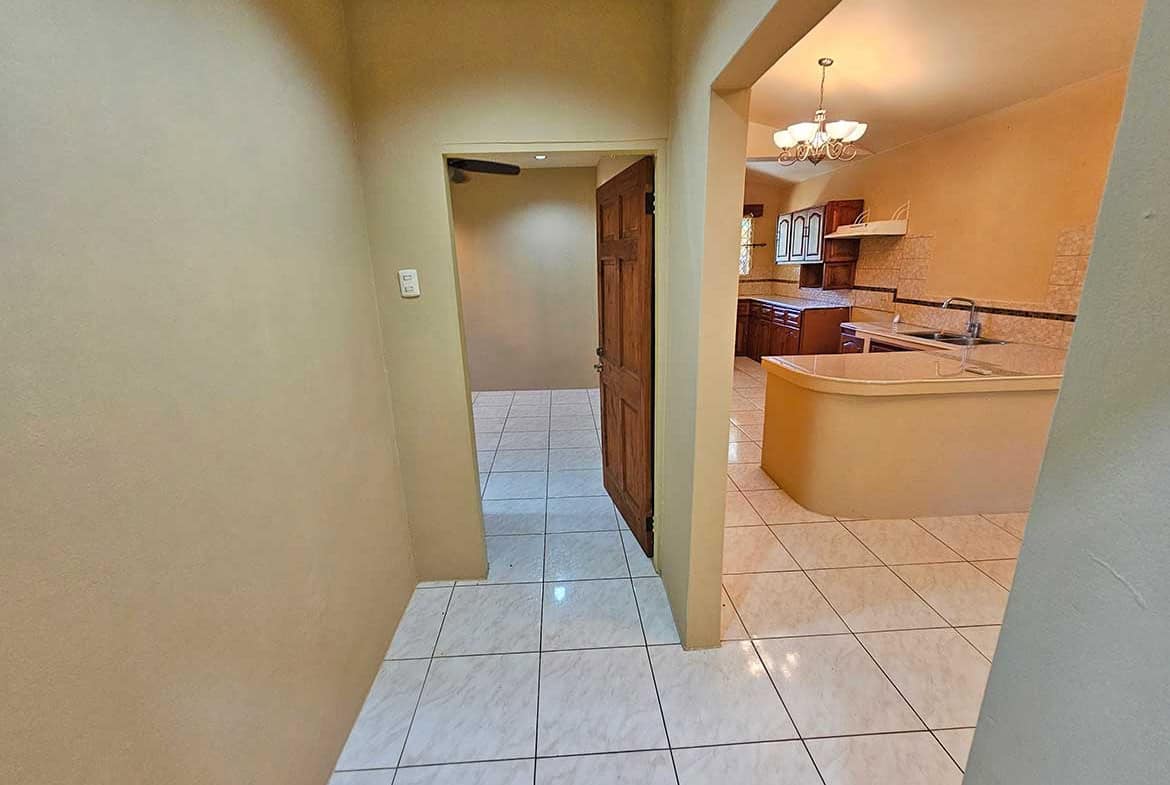 Cornerstone- Spacious hallway leading to kitchen in Calcutta Road apartment.