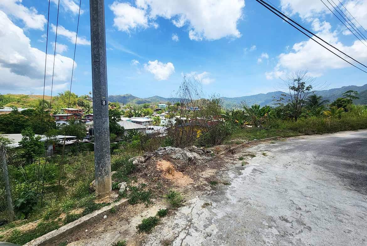 Cornerstone- Rural landscape with power lines and mountains in the background.