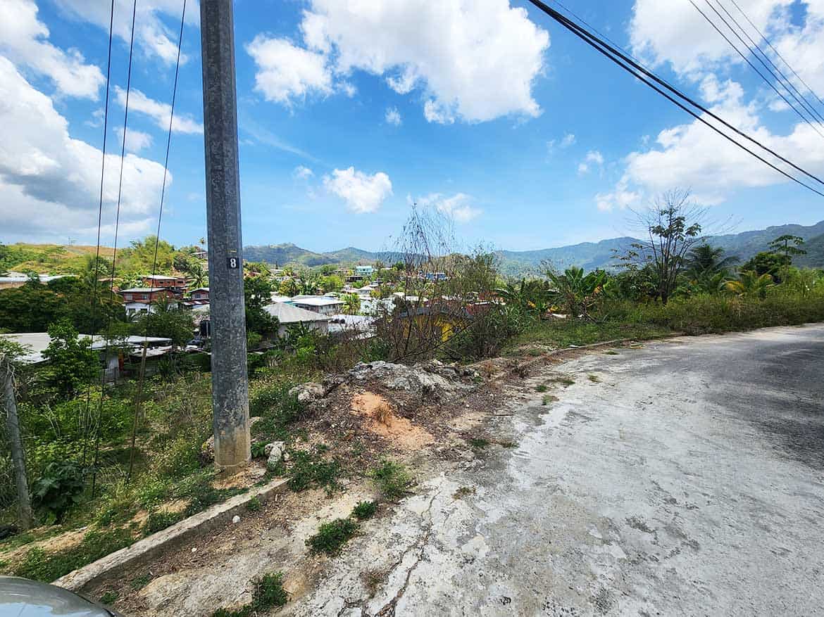 Scenic view near Graceland Heights Cornerstone- Rural landscape with power lines and mountains in the background.