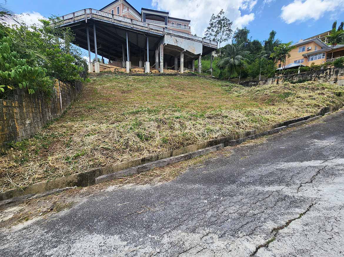 Cornerstone™ Graceland Heights Property Cornerstone- Sloped residential lot with house on top in Graceland Heights.