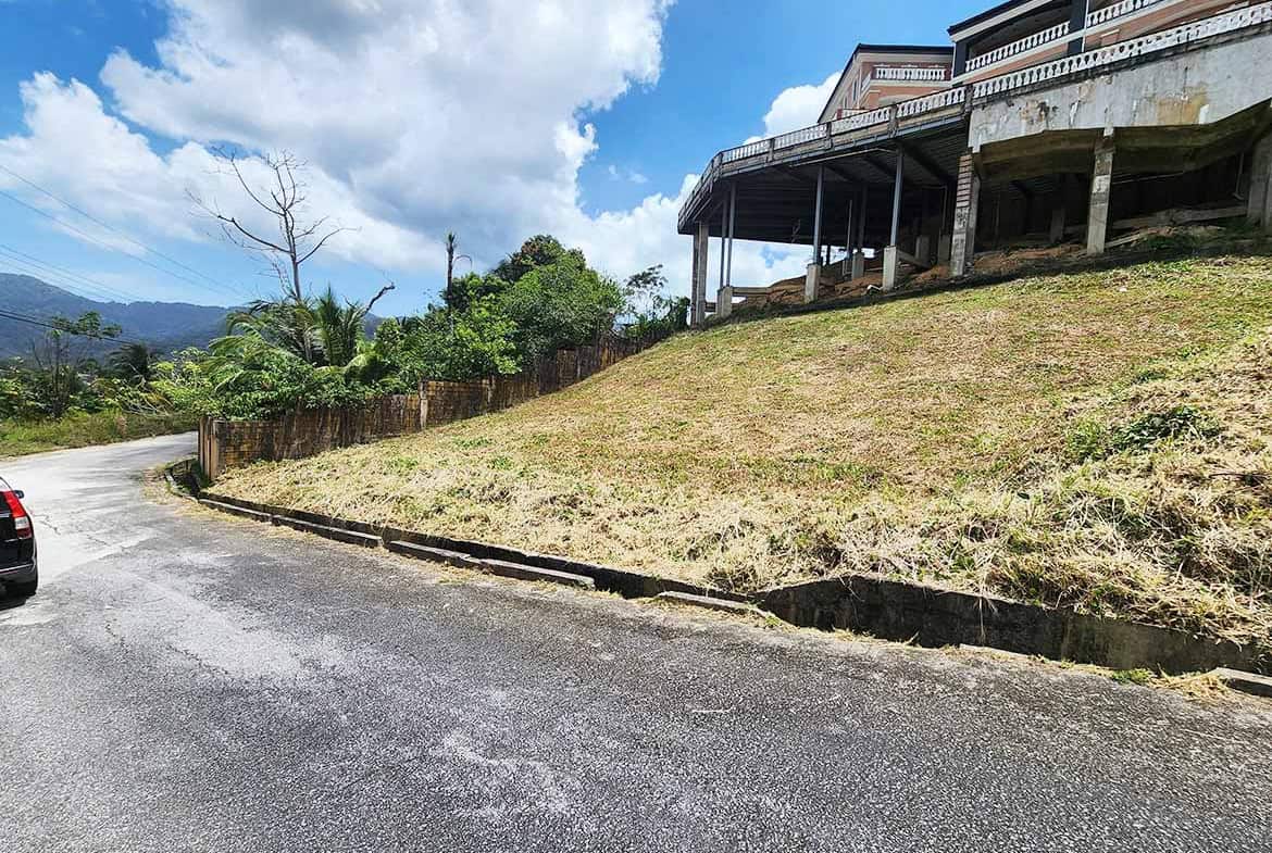Cornerstone- Scenic view of Graceland Heights with house on elevated ground and winding road.