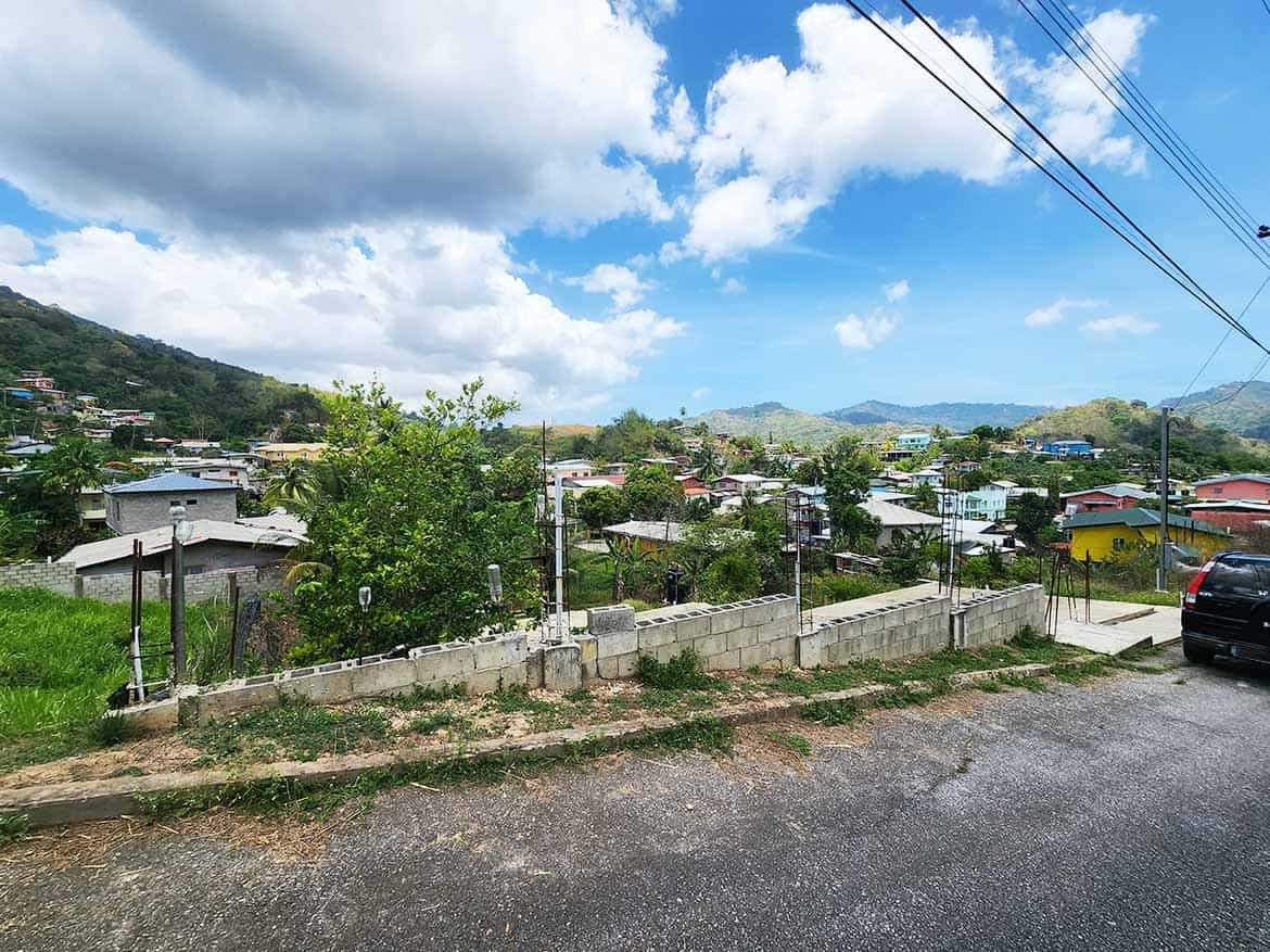 Scenic View of Graceland Heights Cornerstone- View of residential area in Graceland Heights with hills and sky.