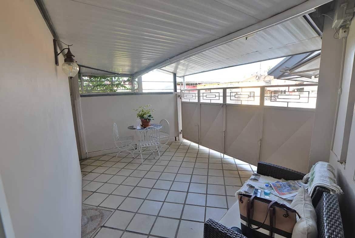 Cornerstone- Balcony with seating area and view in 1-bedroom apartment.