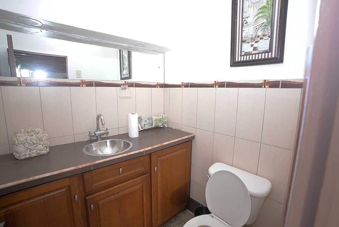 Cornerstone- Small bathroom with sink, toilet, and wall art in Cornerstone™ property.