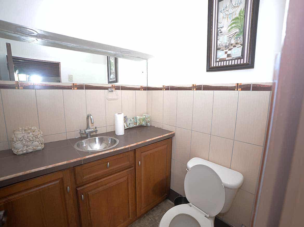 Compact Bathroom with Sink and Toilet Cornerstone- Small bathroom with sink, toilet, and wall art in Cornerstone™ property.