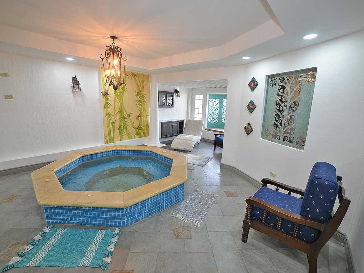 Cornerstone™ 1-Bedroom Apartment Interior Cornerstone- Spacious apartment with hot tub, seating area, and decorative wall art.