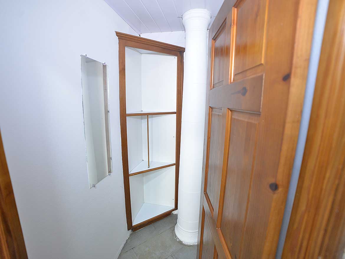 Compact Storage Space in 1-Bedroom Apt Cornerstone- Small built-in corner shelf in a 1-bedroom apartment.