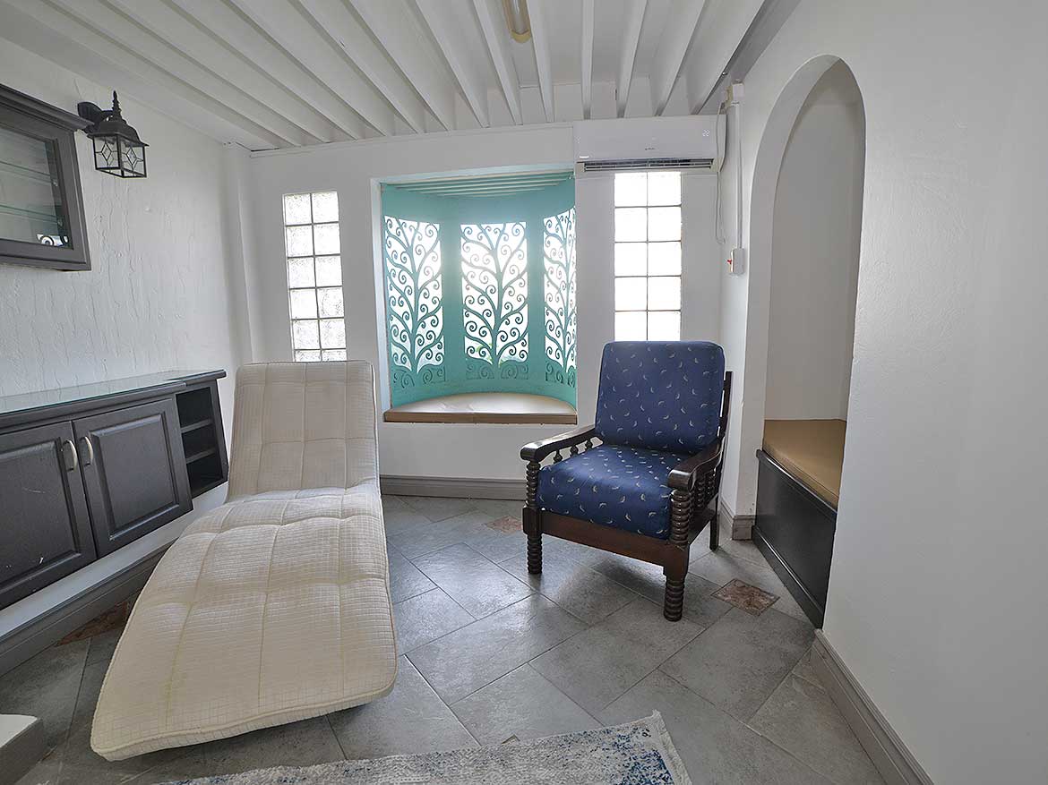 Cozy Living Room in 1-Bedroom Apartment Cornerstone- Bright living room with comfortable seating and decorative window.