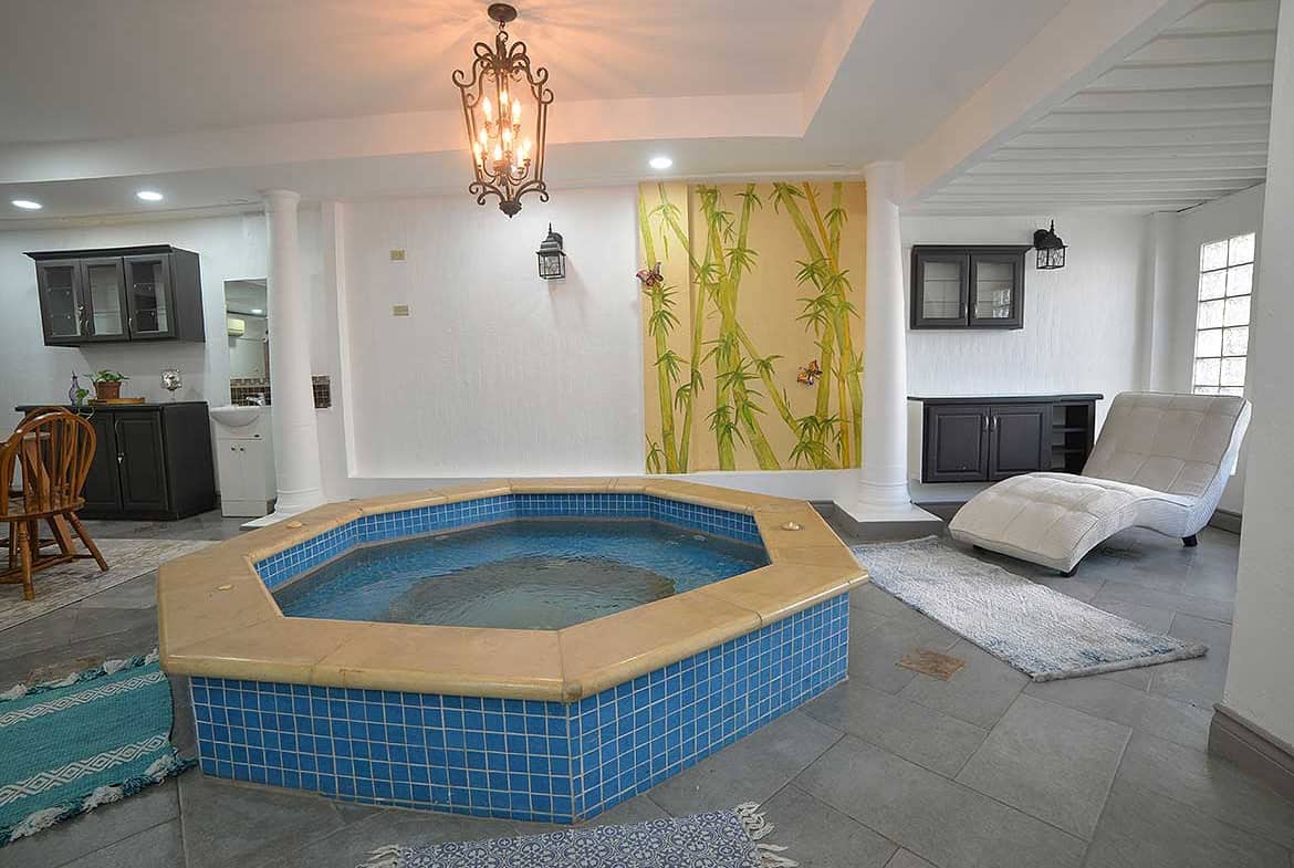 Cornerstone- Indoor pool with blue tiles and relaxing lounge area at Cornerstone.