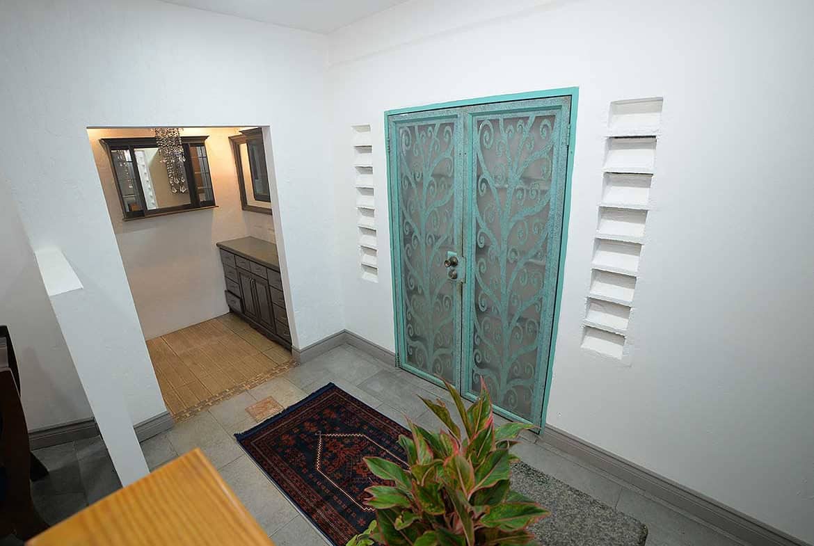 Cornerstone- Entrance to a 1-bedroom apartment with decorative teal door at Cornerstone™.