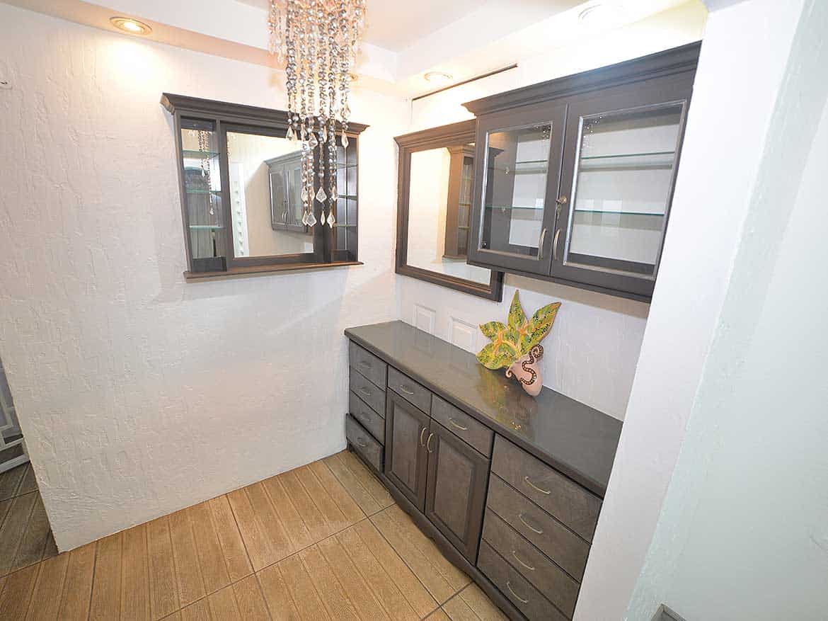 Modern Kitchen with Dark Cabinets Cornerstone- Contemporary kitchen with dark cabinetry and a chandelier.