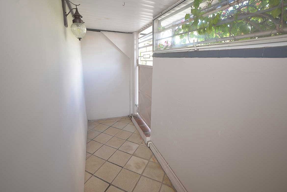 Cornerstone- Small balcony with tiled floor and glass railing at Cornerstone™.