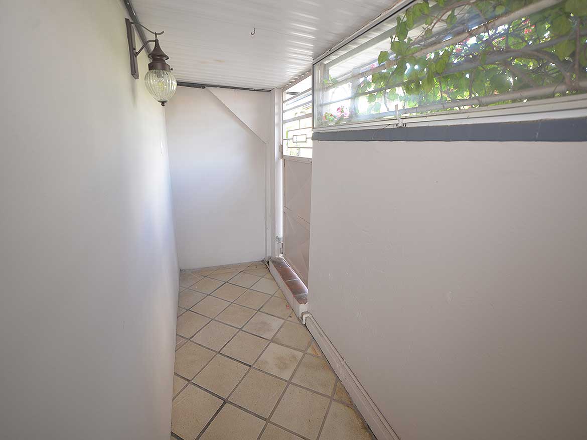 Balcony of 1-Bedroom Apartment Cornerstone- Small balcony with tiled floor and glass railing at Cornerstone™.