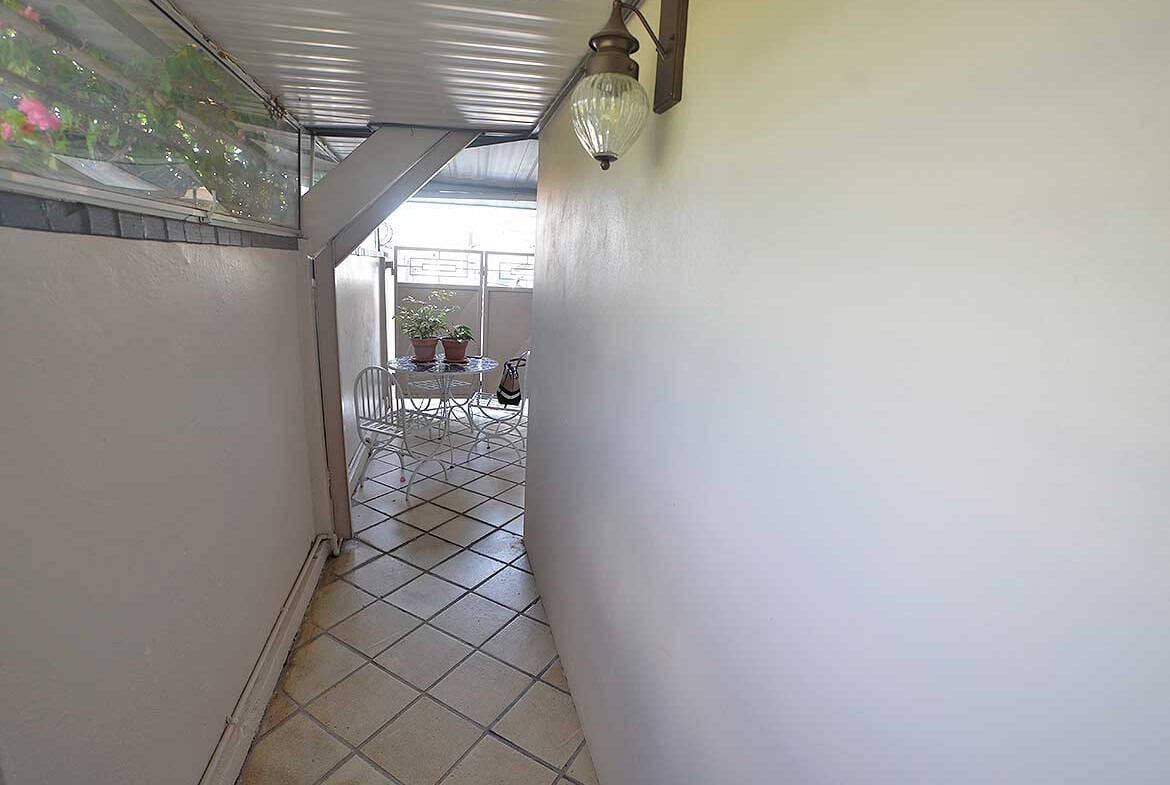 Cornerstone- Balcony with outdoor seating in a 1-bedroom apartment at Cornerstone.