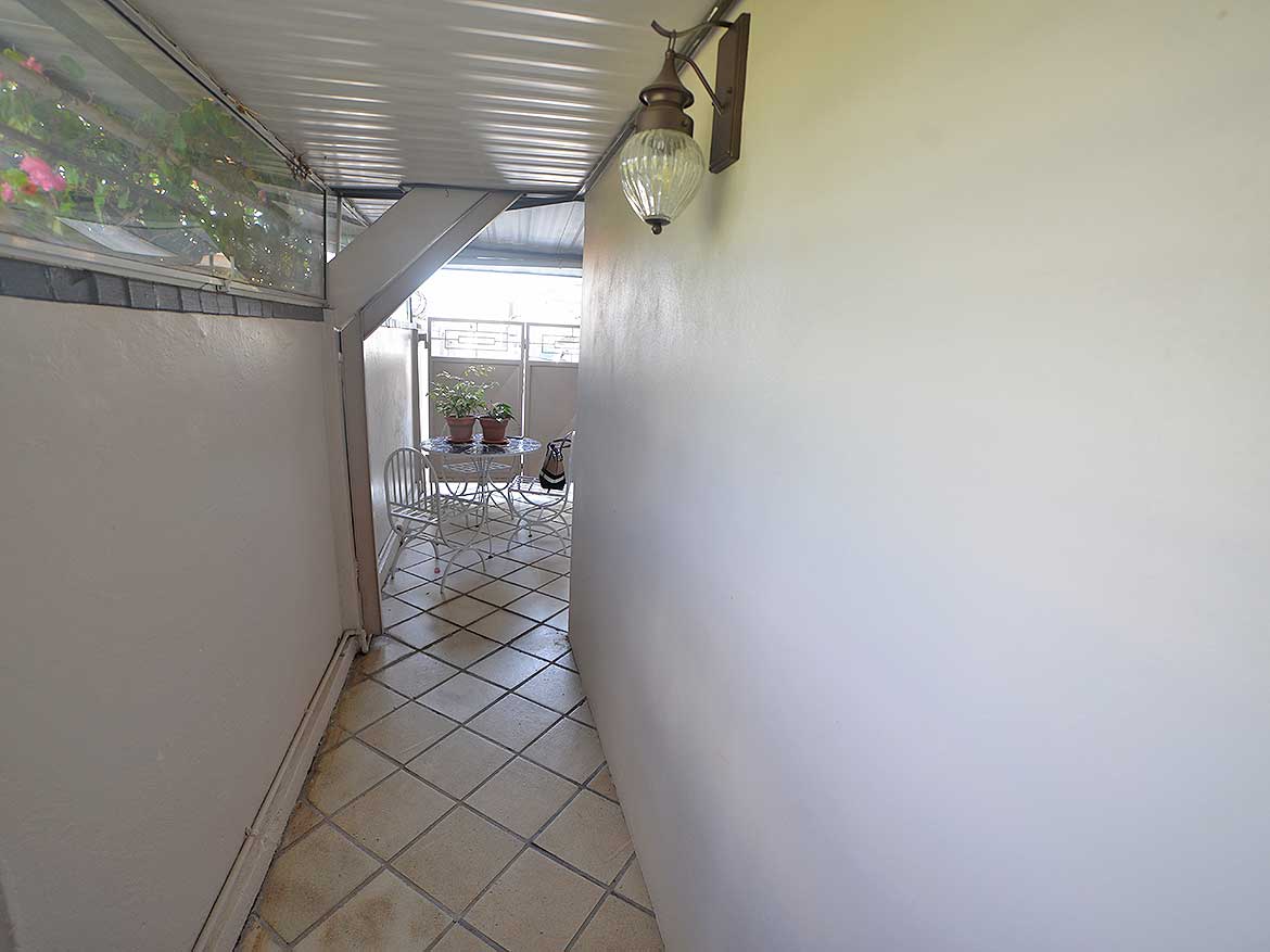 Balcony View of 1-Bedroom Apartment Cornerstone- Balcony with outdoor seating in a 1-bedroom apartment at Cornerstone.