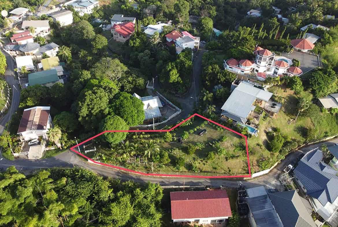 Cornerstone- Aerial view of hilltop land in St Augustine with surrounding houses and greenery.