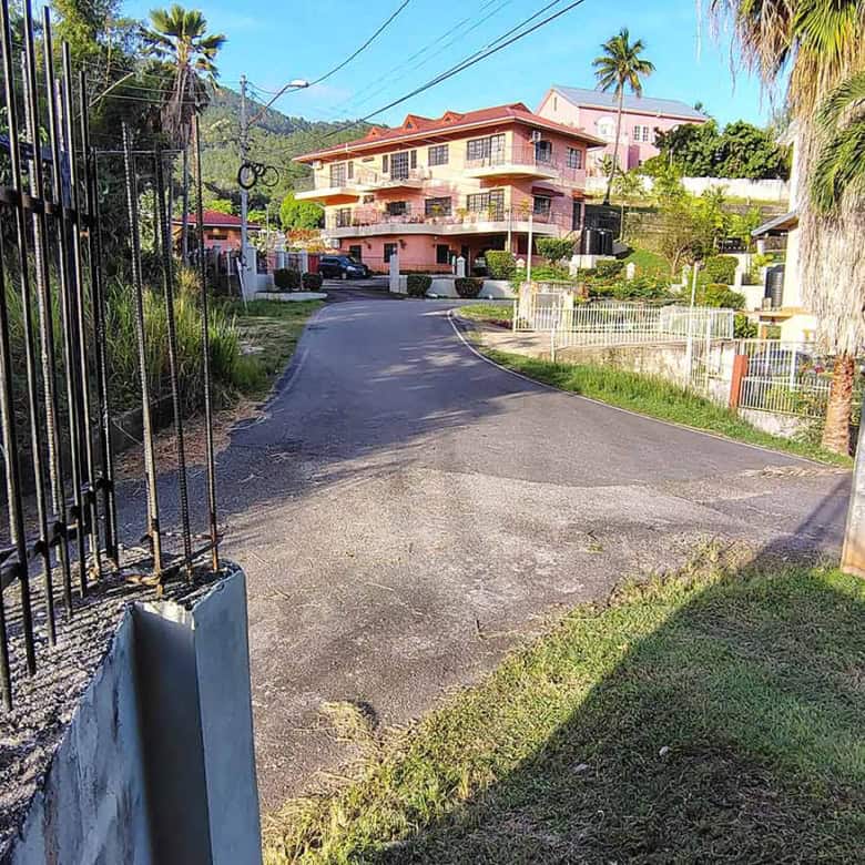 Cornerstone- Residential property on a hilltop in St Augustine with lush greenery and palm trees.