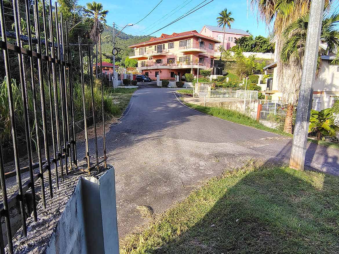 Cornerstone- Residential property on a hilltop in St Augustine with lush greenery and palm trees.