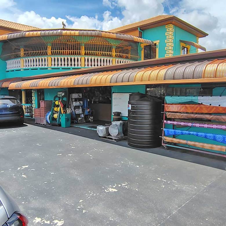 Cornerstone- Colorful commercial building with retail space and parking area.