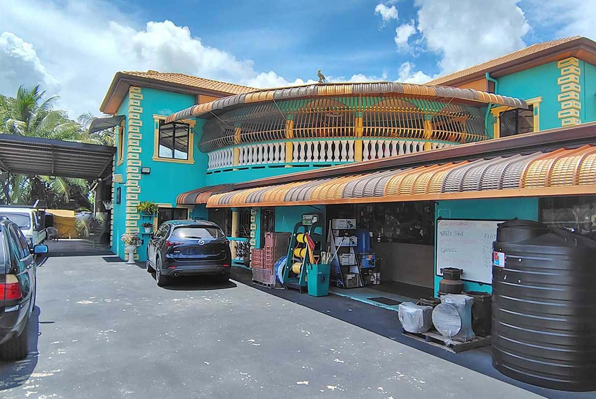 Cornerstone- Colorful building with retail space and parking lot in front.