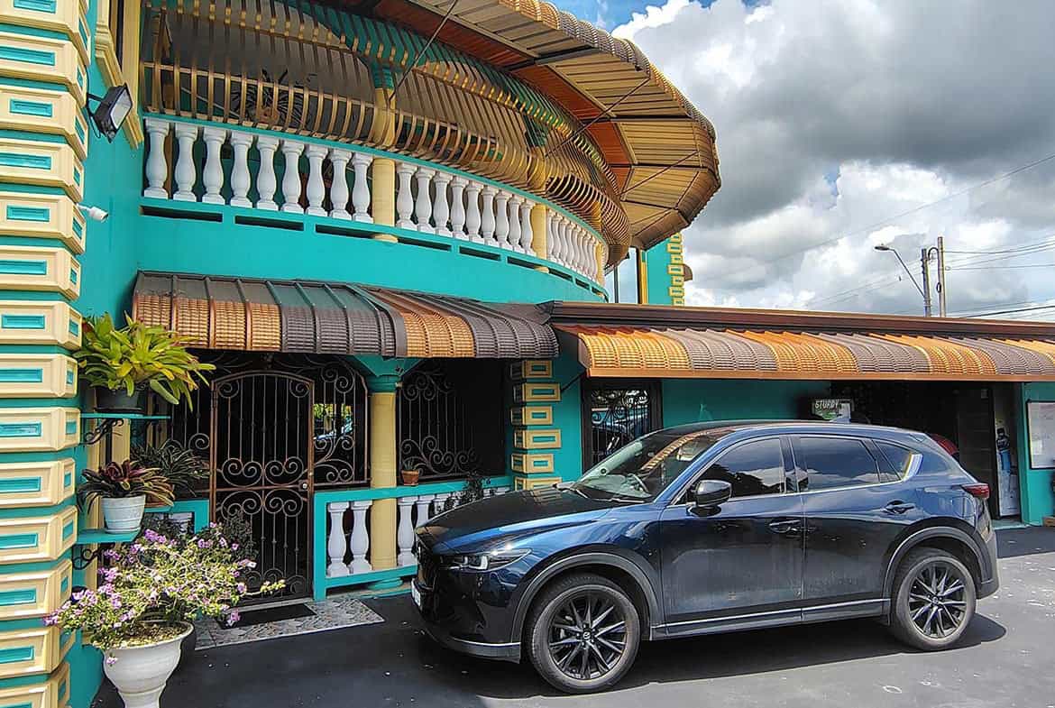 Cornerstone- Modern residence with retail space and vibrant turquoise exterior.
