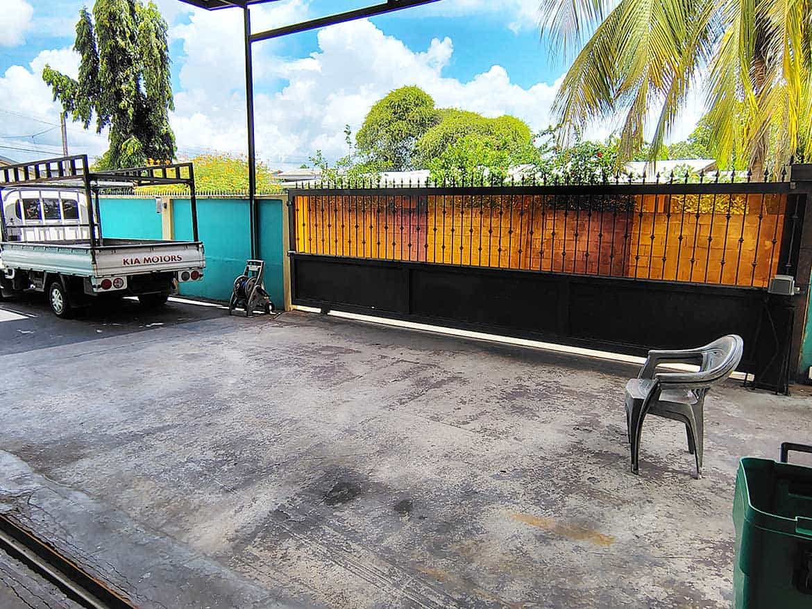 Residential Property with Retail Space Cornerstone- Outdoor view of residence with retail space, gate, and parking area.