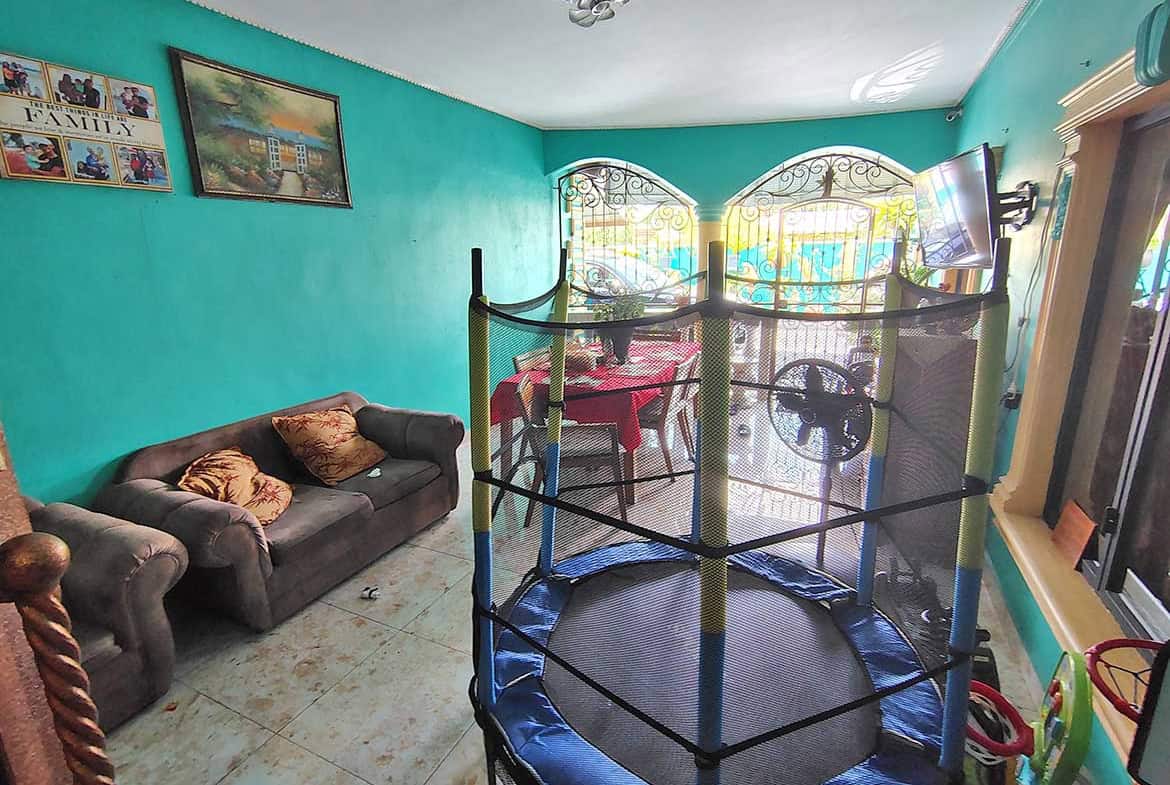 Cornerstone- Living room with trampoline, sofa, and colorful walls in a retail residence.