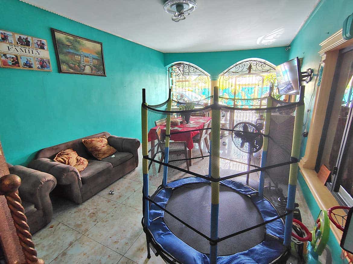 Interior of Residence with Retail Space Cornerstone- Living room with trampoline, sofa, and colorful walls in a retail residence.