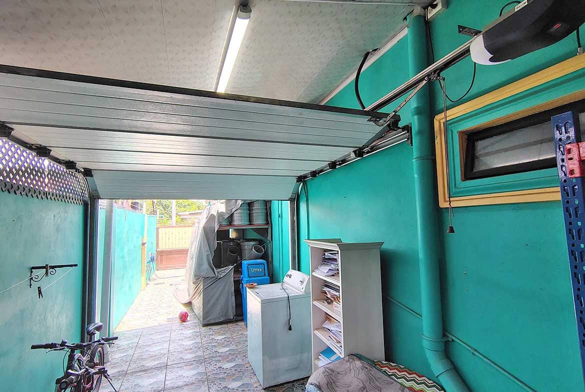 Cornerstone- Garage with laundry appliances and bicycle in a residential property.