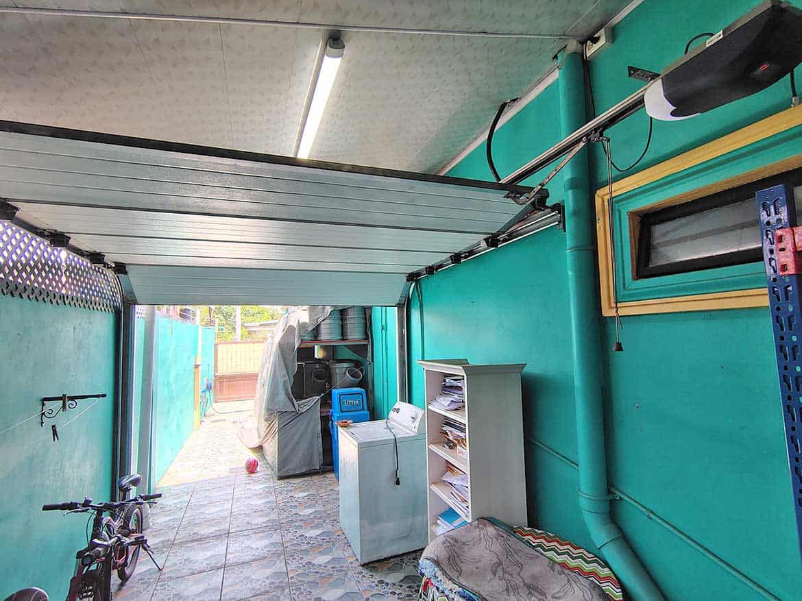 Garage with Laundry Area at Residence Cornerstone- Garage with laundry appliances and bicycle in a residential property.