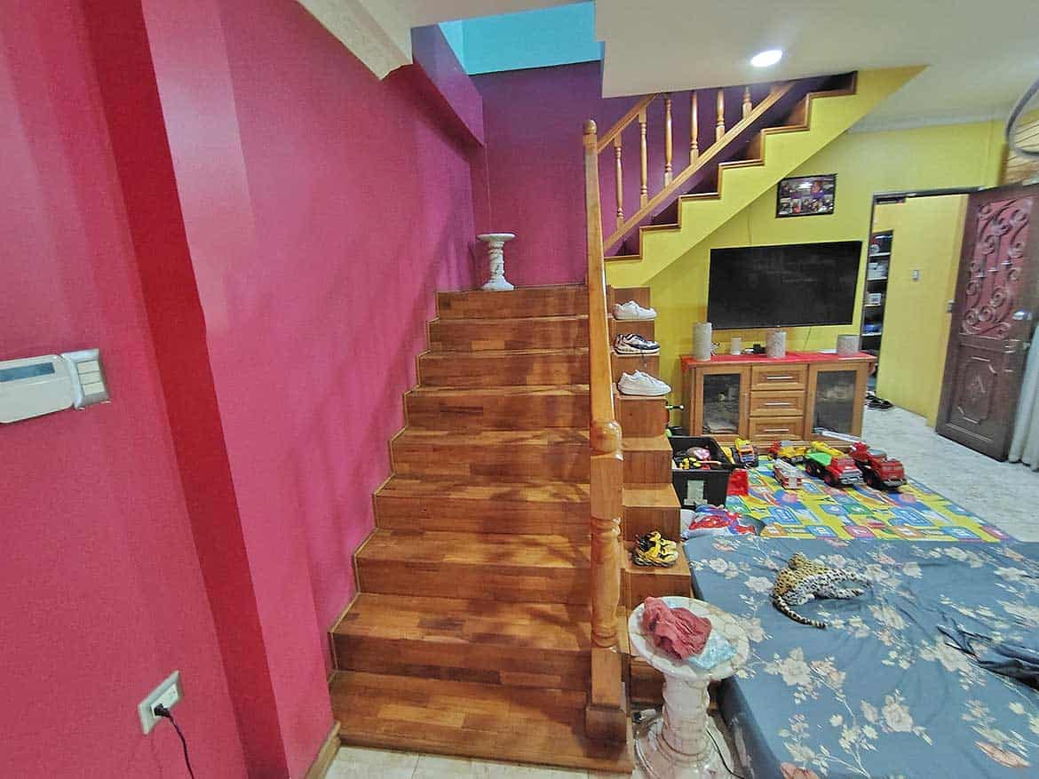Interior of Residence with Retail Space Cornerstone- Colorful living room with staircase and retail area in the background.