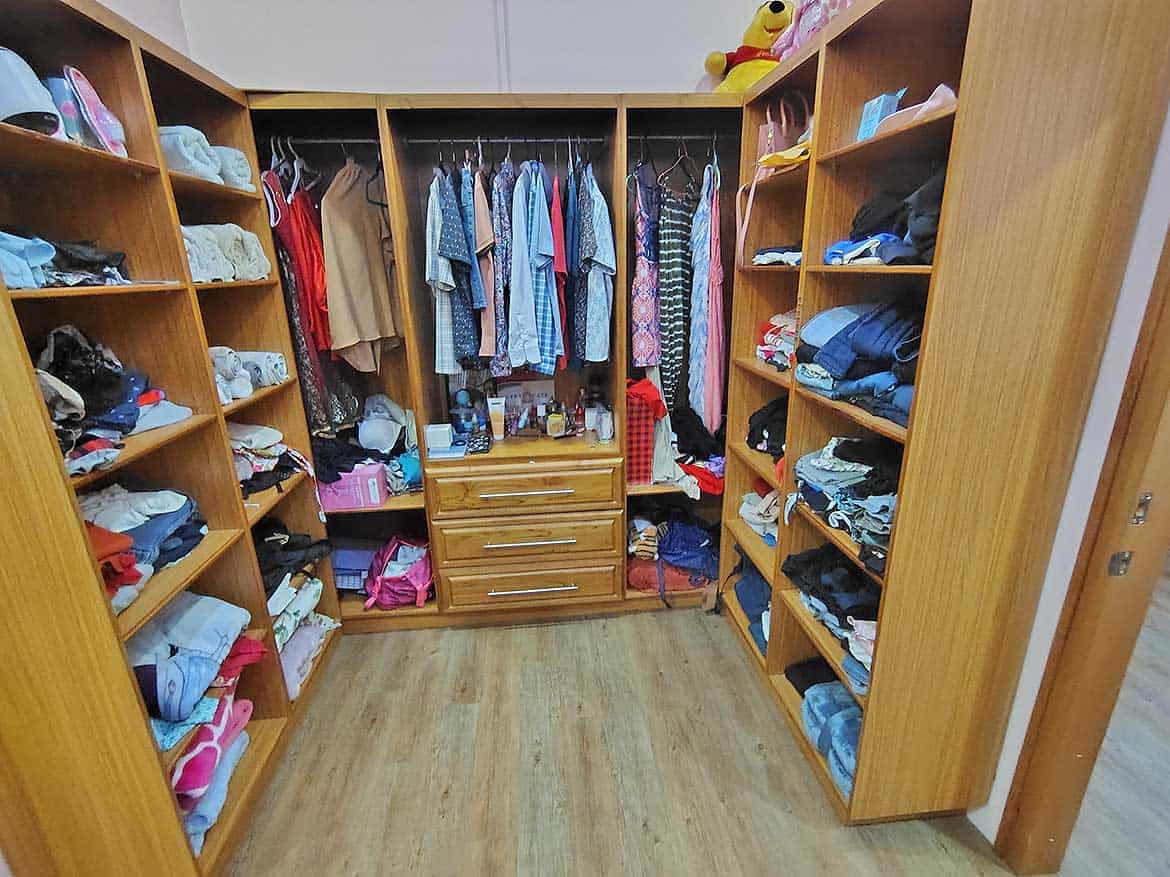 Spacious Walk-in Closet with Storage Cornerstone- Large walk-in closet with organized shelves and hanging space for clothes and accessories.