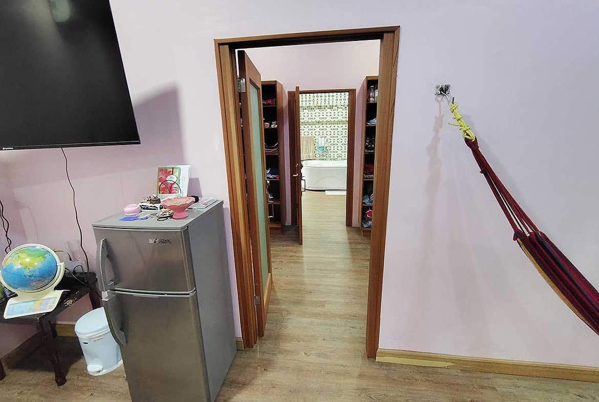 Cornerstone- View of doorway leading to retail area in residence with wooden flooring and wall-mounted TV.
