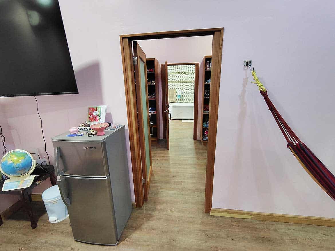 Interior View of Residence with Retail Space Cornerstone- View of doorway leading to retail area in residence with wooden flooring and wall-mounted TV.