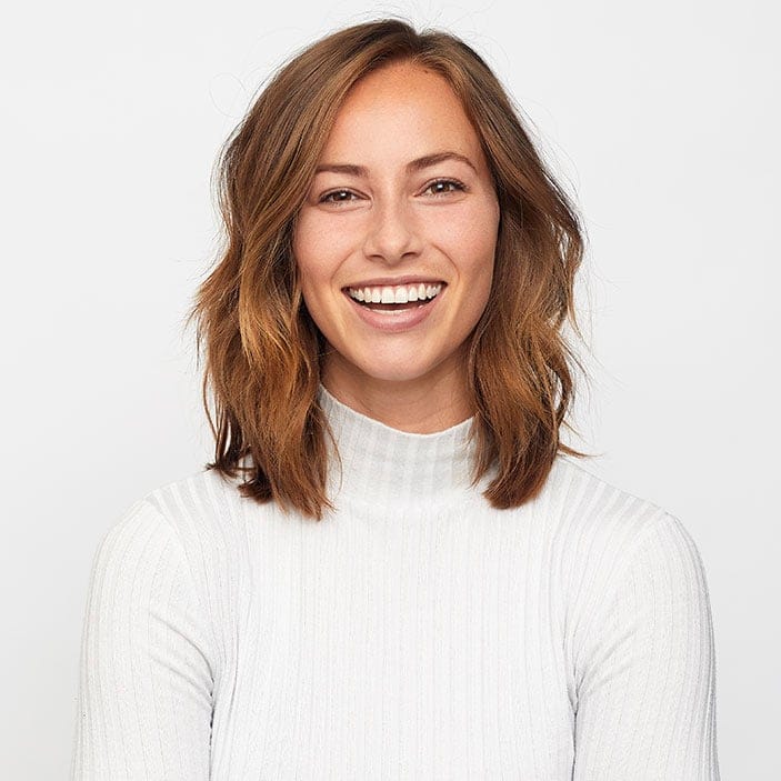 Cornerstone- Happy woman with shoulder-length brown hair smiling at camera.