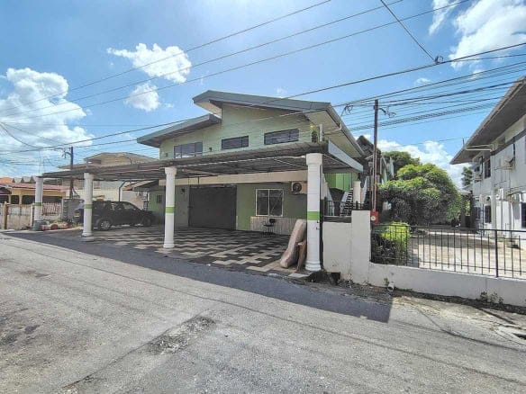 Cornerstone- Residential building at Ganga Terrace, El Socorro with carport and greenery.