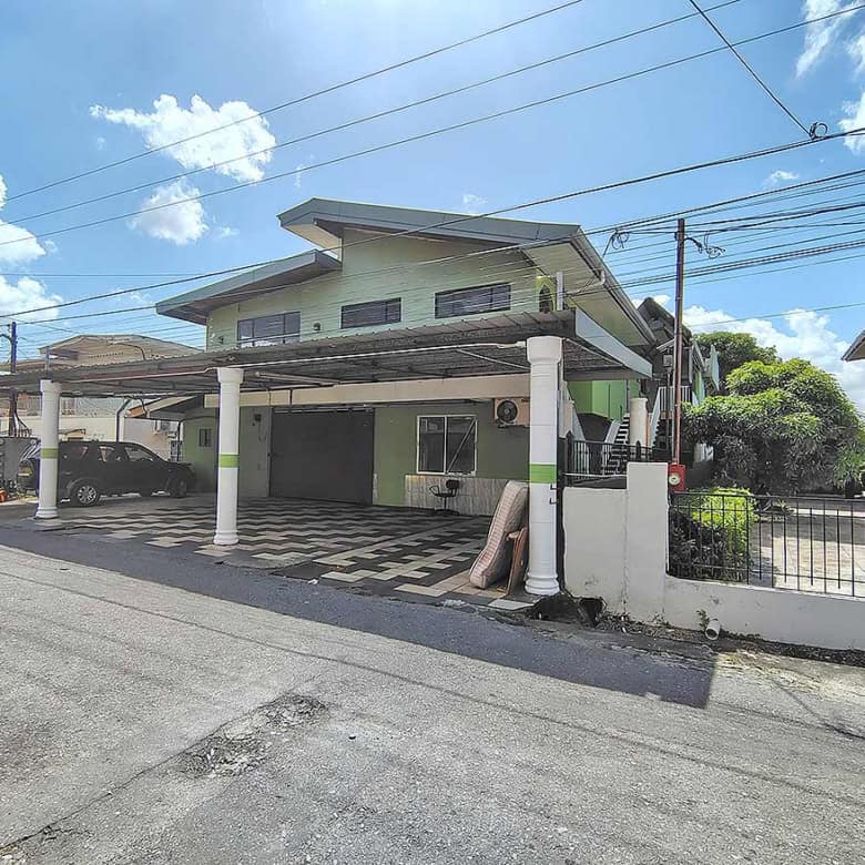 Cornerstone- Residential building at Ganga Terrace, El Socorro with carport and greenery.