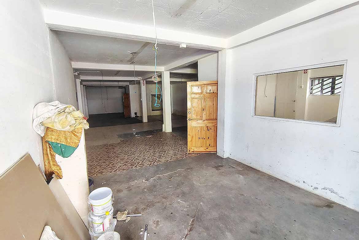 Cornerstone- Empty interior space with white walls and concrete floor at Ganga Terrace, El Socorro.