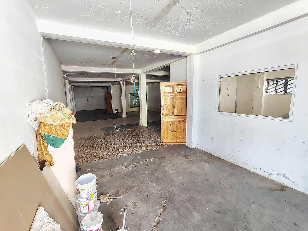 Interior Space at Ganga Terrace Cornerstone- Empty interior space with white walls and concrete floor at Ganga Terrace, El Socorro.