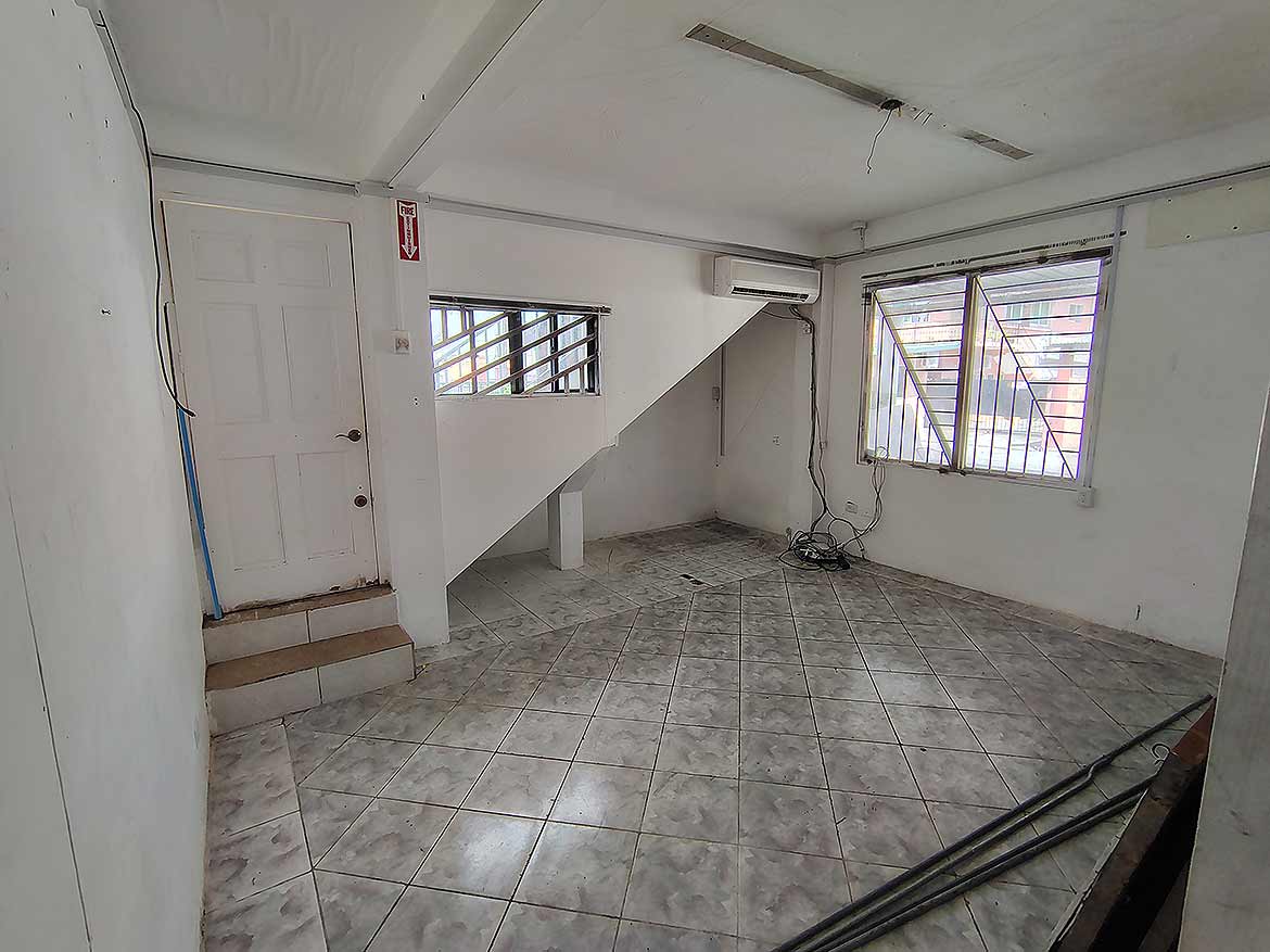 Interior of Ganga Terrace, El Socorro Cornerstone- Spacious room with tiled floor and large windows in Ganga Terrace, El Socorro.