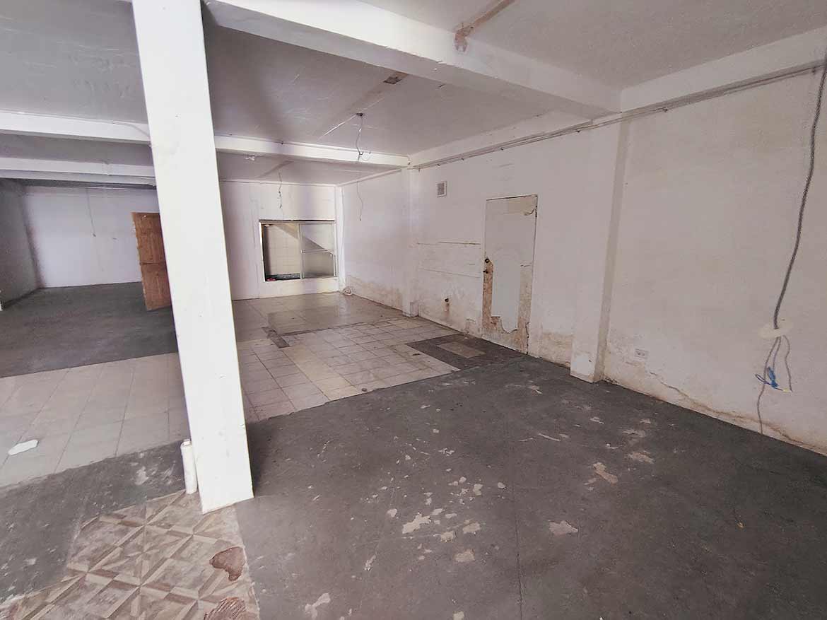 Commercial Space at Ganga Terrace Cornerstone- Empty commercial space with white walls and concrete floor at Ganga Terrace.