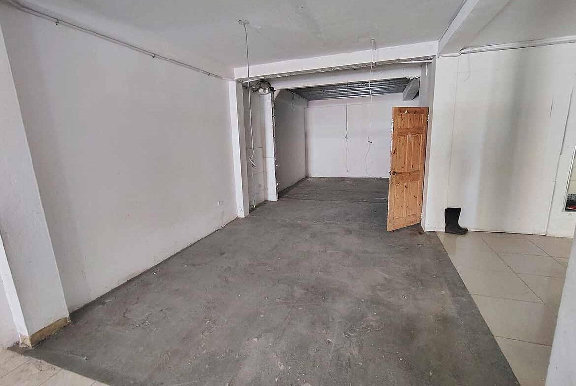 Cornerstone- Empty commercial space at Ganga Terrace, El Socorro with unfinished flooring.