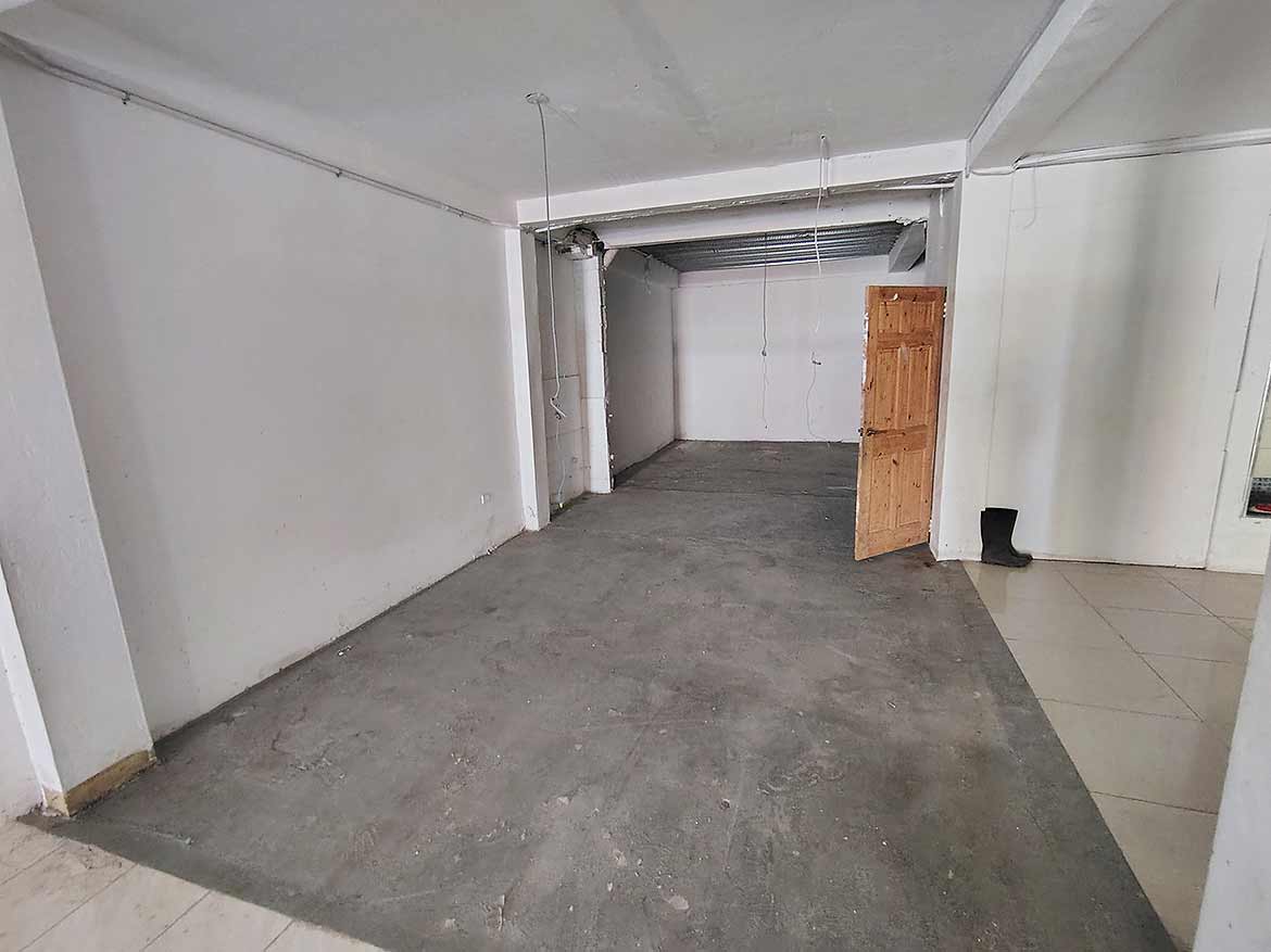 Ganga Terrace Commercial Space Cornerstone- Empty commercial space at Ganga Terrace, El Socorro with unfinished flooring.