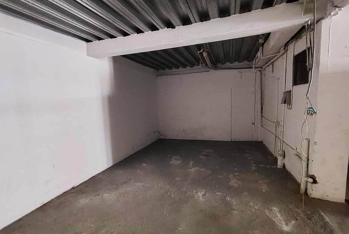 Cornerstone- Empty parking space at Ganga Terrace, El Socorro with concrete floor and ceiling.