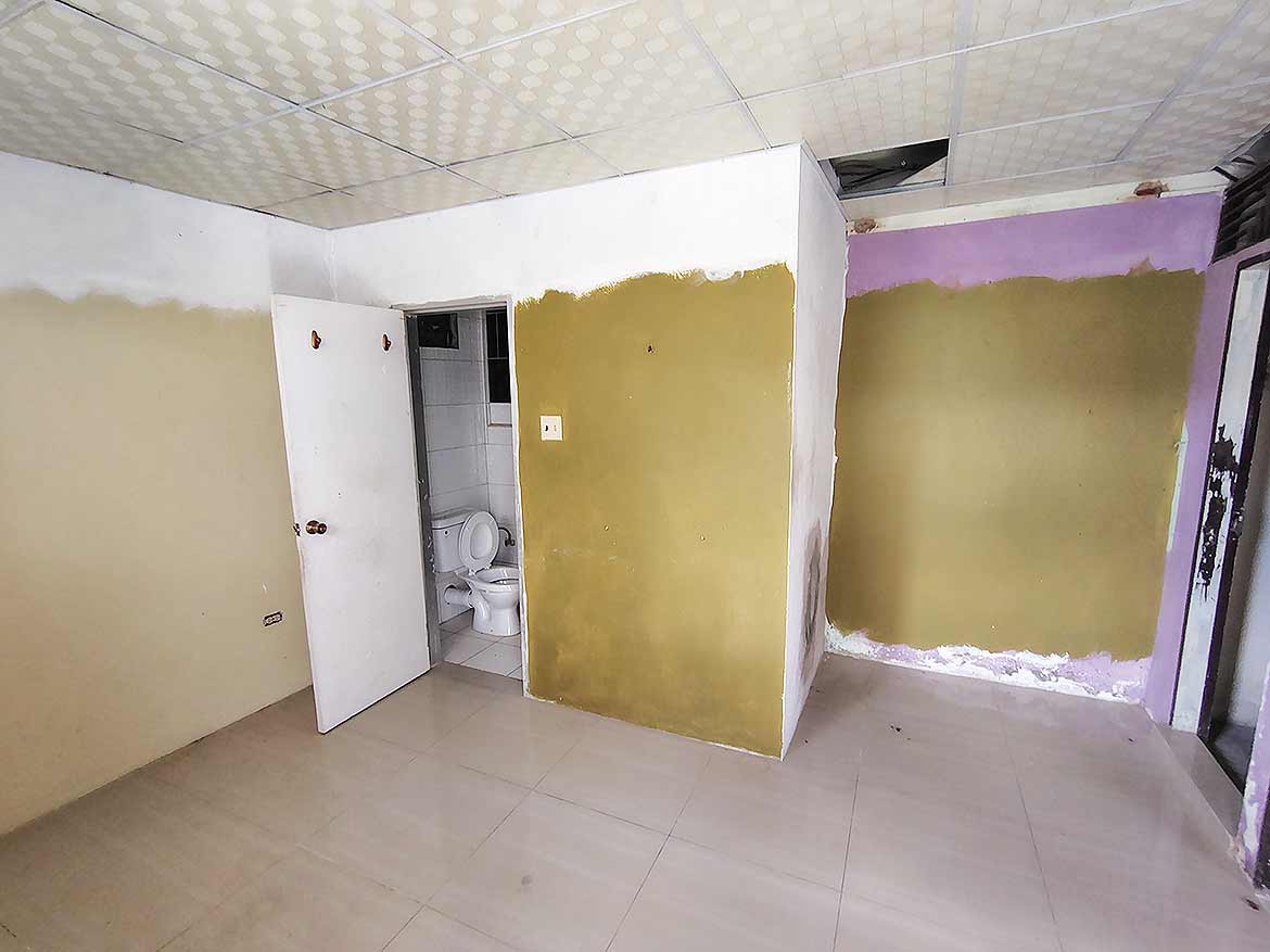 Interior Renovation at Ganga Terrace Cornerstone- Room under renovation with partially painted walls and bathroom visible.