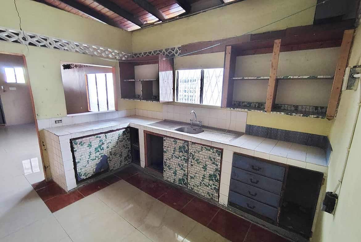 Cornerstone- Renovated kitchen with tiled cabinets and wooden shelves at Ganga Terrace.
