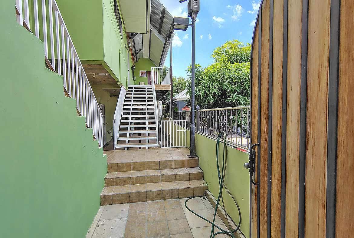 Cornerstone- Exterior view of Ganga Terrace in El Socorro with stairs and greenery.