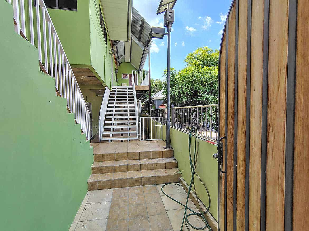 Ganga Terrace Exterior View Cornerstone- Exterior view of Ganga Terrace in El Socorro with stairs and greenery.